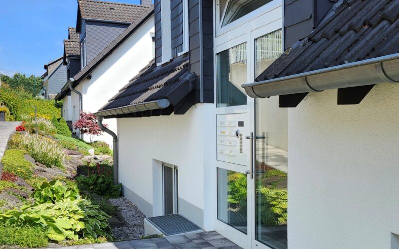 Eingang zur Appartement-Wohnung in Iserlohn-Sümmern. Helle Eingangsanlage mit Briefkästen, Klingeln und Sprechanlage.